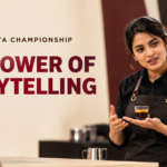 A barista presents a carefully prepared espresso to judges at the World Barista Championship, with a coffee machine and competition setting in the background. Curly Brew editorial cover featuring the headline “The Power of Storytelling